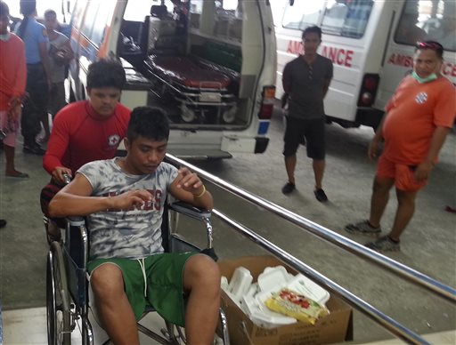 In this Saturday, Sept. 13, 2014 photo released by the Philippine National Red Cross Surigao Del Norte Chapter, a survivor from the ferry M/V Maharlika II that sank after encountering steering problems, is pushed on a wheelchair after arriving at the Lipata Port Terminal in Surigao city, central Philippines. AP