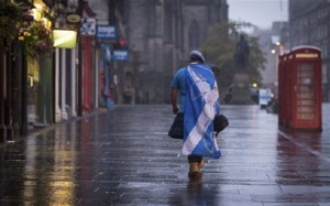 A lone YES campaign supporter walks down a street in Edinburgh after the result of the Scottish independence referendum, Scotland, Friday, Sept. 19, 2014. Scottish voters have rejected independence and decided that Scotland will remain part of the United Kingdom. AP