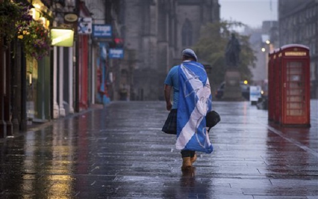 A lone YES campaign supporter walks down a street in Edinburgh after the result of the Scottish independence referendum, Scotland, Friday, Sept. 19, 2014. Scottish voters have rejected independence and decided that Scotland will remain part of the United Kingdom. AP