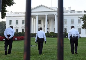 Uniformed Secret Service officers walk along the lawn on the North side of the White House in Washington, Saturday, Sept. 20, 2014. The Secret Service is coming under renewed scrutiny after a man scaled the White House fence and made it all the way through the front door before he was apprehended. AP