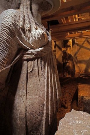 This photo released on Thursday, Sept. 11, 2014 by the Greek Culture Ministry shows two approximately life-sized female statues on a wall leading to a yet unexplored inner room of a huge underground ancient tomb, in Amphipolis, northern Greece. AP