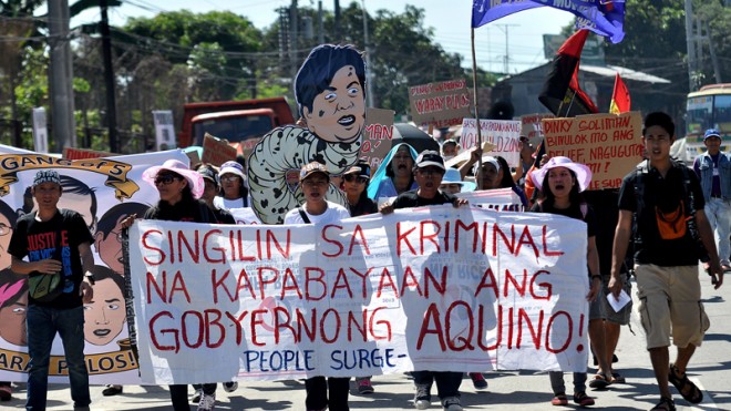 Survivors of Typhoon "Yolanda" stage a protest inside the compound of the Department of Social Welfare and Development in Quezon City on March 28, 2014, to show their dismay over the rotten relief goods being distributed five months after the typhoon. They also called for the resignation of DSWD Secretary Dinky Soliman.  INQUIRER PHOTO / RICHARD A. REYES 
