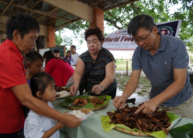 Sinag officers in Plaridel, Bulacan, serve indigent kids nutritious food produced by local farmers and fishermen.