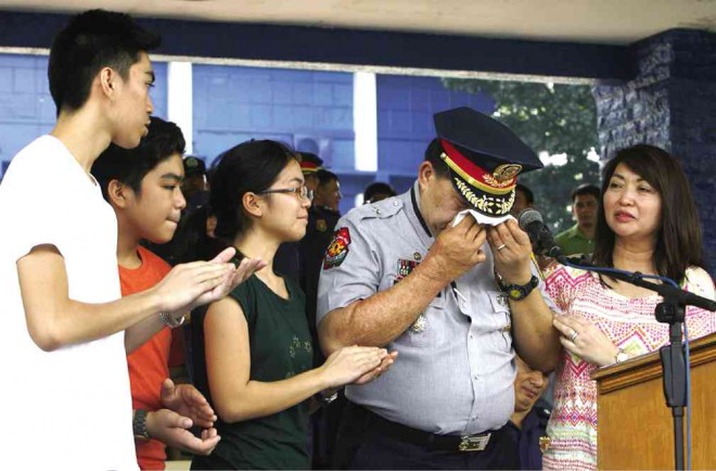 DIRECTOR’S DEEPEST CUT Bidding farewell to the QCPD, Chief Supt. Richard Albano tears up while  surrounded by family members after his speech at Camp Karingal on Friday. RAFFY LERMA