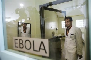  In this Oct. 21, 2014 file photo, Dr. Mark Christopher Pasayan of the Research Institute for Tropical Medicine emerges from one of the isolation rooms during a media tour of the facility to show the government's readiness in dealing with the still Ebola-free country at Alabang, Muntinlupa city, south of Manila, Philippines. AP