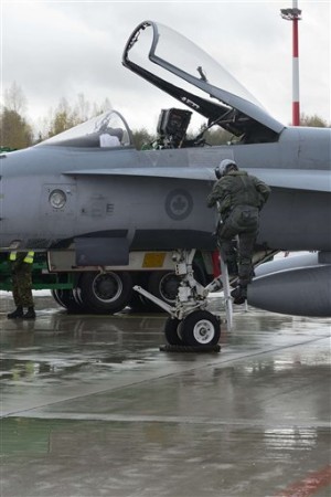 A pilot climbs from a Canadian Air Force F-18 Hornet at Siauliai Air Base in Lithuania Monday Oct. 20, 2014 . AP FILE PHOTO