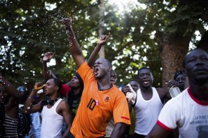 In this photo taken Thursday, Oct. 30, 2014, protesters shout out as they go on a rampage near the parliament building in Burkina Faso as people protest against their longtime President Blaise Compaore who seeks another term, in Ouagadougou, Burkina Faso. AP