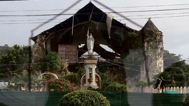SOLID FAITH This is how the historic Loboc town church looks now, a year after a powerful earthquake struck Bohol province and heavily damaged or destroyed hundreds of houses and dozens of churches. MARIANNE BERMUDEZ