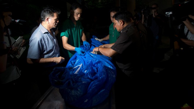 In this Tuesday, Sept. 16, 2014 file photo, the body of one of slain British tourists, Hannah Witheridge, wrapped in plastic sheet, is carried at a forensic police facility in Bangkok, Thailand. Police Maj. Gen. Kiattipong Khawsamang said Thursday, Oct. 2 that two out of three Myanmar workers questioned by police admitted murdering Witheridge, 23, and David Miller, 24. (AP Photo/Sakchai Lalit, File)
