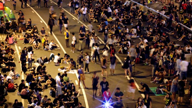 Student pro-democracy protesters continue to occupy the streets near government headquarters Sunday, Oct. 5, 2014, in Hong Kong. They remained stubbornly encamped outside the city's government headquarters in the early hours of Monday, with no sign that they would meet a deadline to clear the area by morning.  AP PHOTO/WONG MAYE-E 