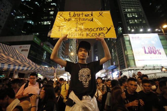 Pro-democracy student protesters stand their ground in their encampment while surrounded by local residents demanding them to leave in Mong Kok, Hong Kong, Friday, Oct. 3, 2014. AP FILE PHOTO