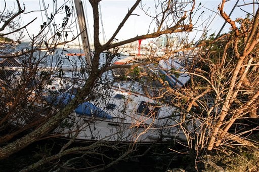 Yachts that have broken way from their moorings sit on a rock in Hamilton Harbour after hurricane Gonzalo hit the island in Hamilton, Bermuda, Saturday Oct. 18, 2014. AP