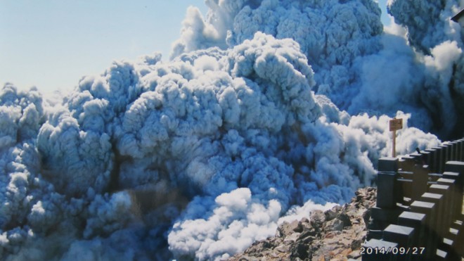 FILE - In this Saturday, Sept. 27, 2014 file photo taken by 59-year-old hiker Izumi Noguchi who fell victim to the eruption of Mount Ontake, and was offered to Kyodo News by his wife, Hiromi, Friday, Oct. 3, dense plumes of gases and ash billow from the summit crater of Mount Ontake as the volcanic mountain starts to erupt in central Japan. Construction company employee Noguchi was climbing alone, as his usual hiking companion, Hiromi, had to work, she told Japanese broadcaster NHK and other media. His compact camera was banged up, but the memory chip inside was undamaged. She printed all 100 shots. (AP Photo/Kyodo News, Izumi Noguchi, File)