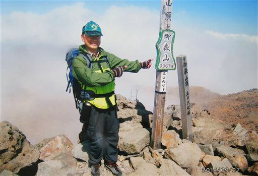 In this Satuday, Sept. 27, 2014 photo found in a camera possessed by 59-year-old hiker Izumi Noguchi who fell victim to the eruption of Mount Ontake, and was offered to Kyodo News by his wife, Hiromi, Friday, Oct. 3, Noguchi poses on the summit of Mount Ontake shortly before the eruption of the volcanic mountain in central Japan. AP 