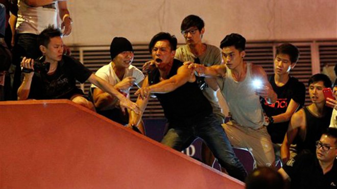 Pro-democracy student protesters shout at police in Mong Kok, Hong Kong, early Saturday, Oct. 4, 2014. Pushing and yelling, hundreds of Hong Kong residents tried to force pro-democracy activists from the streets they were occupying Friday as tensions rose in the weeklong protests that have shut down parts of the city. AP Photo