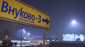 In this image from a video provided by the APTN, TV crews of different channels gather near the gates to Vnukovo 3 business airport outside Moscow, Russia, Monday night, Oct. 20, 2014. AP