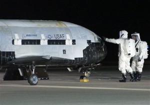 In this Dec. 3, 2010, file image provided by the Vandenberg Air Force Base shows technicians examining the X-37B unmanned spaceplane shortly after landing at Vandenberg Air Force Base, Calif. AP