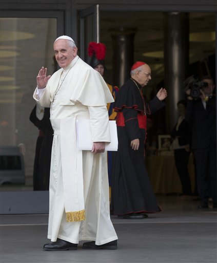 Pope Francis waves as he arrives at a morning session of a two-week synod on family issues, at the Vatican, Thursday, Oct. 16, 2014. AP 
