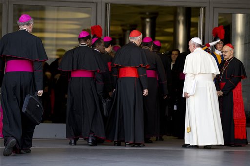 Pope Francis, right, arrives with bishops and cardinals to attend an afternoon session of a two-week synod on family issues at the Vatican, Saturday, Oct. 18, 2014. Catholic bishops scrapped their landmark welcome to gays Saturday, showing deep divisions at the end of a two-week meeting sought by Pope Francis to chart a more merciful approach to ministering to Catholic families.  AP PHOTO/ANDREW MEDICHINI 