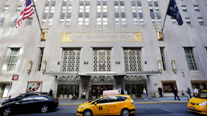 In this Oct. 6, 2014 file photo, a taxi passes in front of the fabled Waldorf Astoria hotel in New York. Concerned about potential security risks, the U.S. government is taking a close look at last week’s sale of New York’s iconic Waldorf Astoria hotel to a Chinese insurance company. U.S. officials said Monday they are reviewing the Oct. 6 purchase of the Waldorf by the Beijing-based Anbang Insurance Group, which bought thehotel from Hilton Worldwide for $1.95 billion. Terms of the sale allow Hilton to run the hotel for the next 100 years and call for “a major renovation” that officials say has raised eyebrows in Washington, where fears of Chinese eavesdropping and cyber espionage run high. (AP Photo/Mark Lennihan, File)