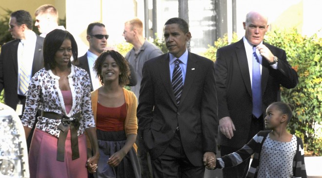 President Barack Obama, first lady Michelle Obama and their, children Sasha, right, and Malia, second from left, walk back to the White House in this 2009 file photo. AP