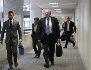 CIA Director John Brennan, center, departs after a closed briefing with the Senate Intelligence Committee and its chair Sen. Dianne Feinstein, D-Calif., on Capitol Hill in Washington. AP