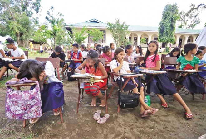 STUDENTS of Camalig North Central School in Camalig, Albay, attend their classes outdoors as their classrooms serve as temporary homes for  families whose houses are within the  6-kilometer permanent danger zone of Mayon Volcano. MARK ALVIC ESPLANA/INQUIRER SOUTHERN LUZON 