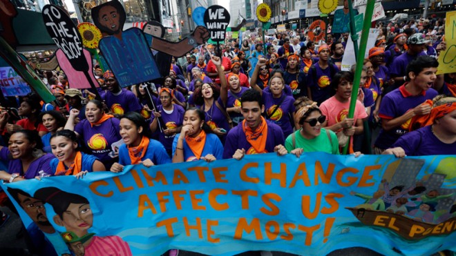 In the Sept. 21, 2014 file photo thousands of young people fill the streets of Manhattan, New York, carrying banners and calling on policymakers to take action on climate change. According to a new Associated Press-GfK poll, conducted September 25-29, 2014, Americans lack confidence that their government can keep them safe from threats to their safety and economic security. More than half of those polled don’t think the U.S. government can do much to effectively minimize the threat posed by climate change, mass shootings, racial tensions, economic uncertainty on Wall Street and an unstable job market. (AP Photo/Mel Evans, File)