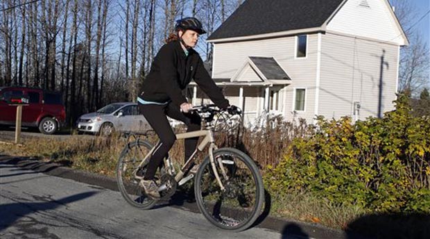 Nurse Kaci Hickox leaves her home on a rural road in Fort Kent, Maine, to take a bike ride with her boyfriend Ted Wilbur, Thursday, Oct. 30, 2014. The couple went on an hour-long ride followed by a Maine State Trooper. State officials are going to court to keep Hickox in quarantine for the remainder of the 21-day incubation period for Ebola that ends on Nov. 10. Police are monitoring her, but can't detain her without a court order signed by a judge. AP 