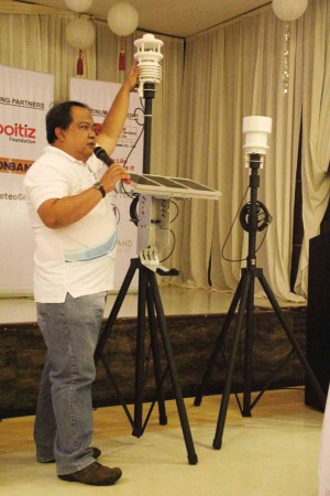 ALVIN Tobias, operations and maintenance supervisor of Weather Philippines Foundation Inc., presents and explains the use of the pair of gadgets provided to local government units to monitor climate situations in the localities for use in disaster mitigating actions of the communities. JUAN ESCANDOR JR. 