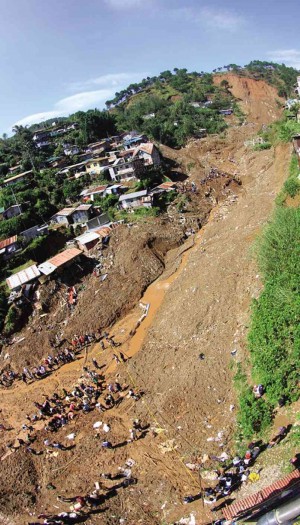 RESCUERS dig through mud for survivors a day after a massive landslide wiped out a section of the community of Little Kibungan in La Trinidad, Benguet in 2009. EV ESPIRITU 