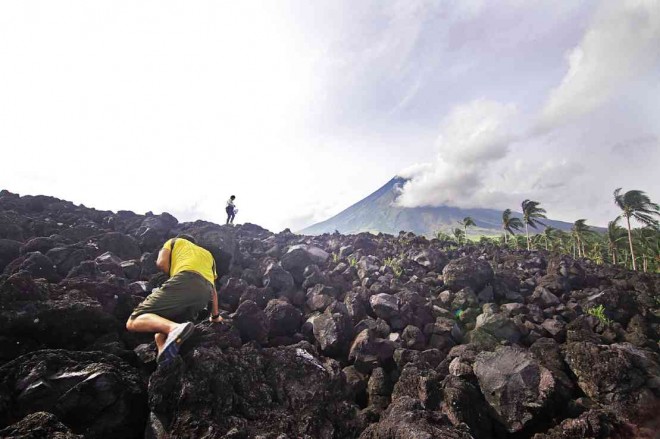 MAYON LAVA FRONT A lava wall, almost the height of a four-story building, covered a coconut plantation when Mayon Volcano spewed lava in 2009 in Barangay (village) Mabinit, which is part of the 6-kilometer permanent danger zone in Legazpi City. MARK ALVIC ESPLANA/INQUIRER SOUTHERN LUZON