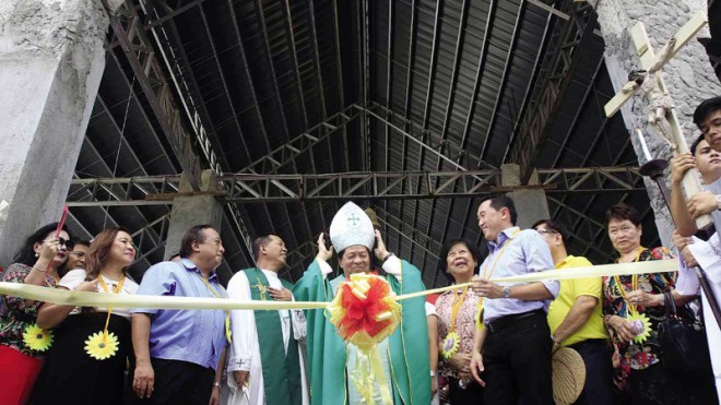 NEW HOPE  An alternative church is opened by Bishop Leonardo Medroso in Loboc town, Bohol province, where three churches were flattened during the Oct. 15, 2013, quake.  MARIANNE BERMUDEZ