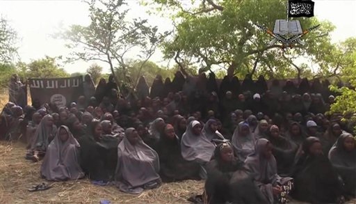 This Monday May 12, 2014 file image taken from video by Nigeria's Boko Haram terrorist network, shows the alleged missing girls abducted from the northeastern town of Chibok. Nigeria’s government and Islamic extremists from Boko Haram have agreed to an immediate cease-fire, officials said Friday Oct. 17, 2014. The fate of more than 200 missing schoolgirls abducted by the insurgents six months ago remains unclear. Defense Ministry spokesman Maj. Gen. Chris Olukolade said their release is still being negotiated. AP
