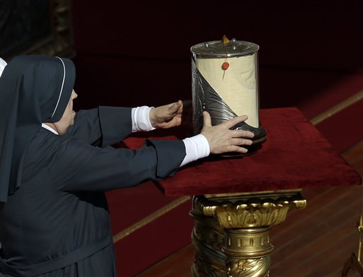 A nun carries a relic of late Pontiff Paul VI during the beatification ceremony and a mass for the closing of of a two-week synod on family issues celebrated by Pope Francis, in Saint Peter's Square at the Vatican, Sunday, Oct. 19, 2014.  AP PHOTO