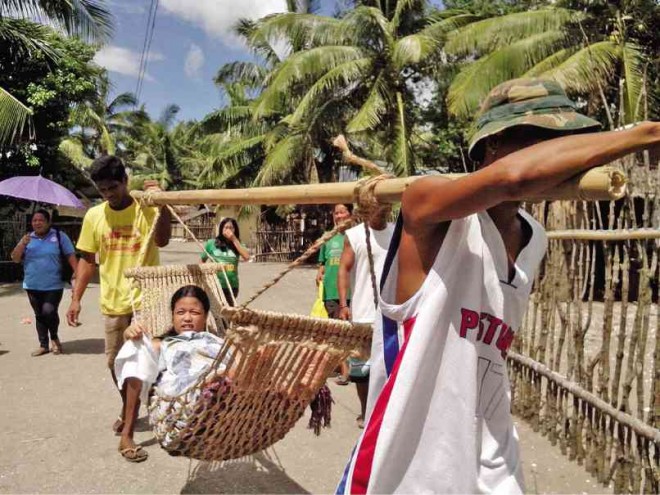 RESIDENTS and relatives of pregnant women in hard-to-reach areas of Tinambac, Camarines Sur, are carried in hammocks to a birthing clinic in Sagrada or the municipal health center to give birth in a safe sanitary environment. SHIENA M. BARRAMEDA 