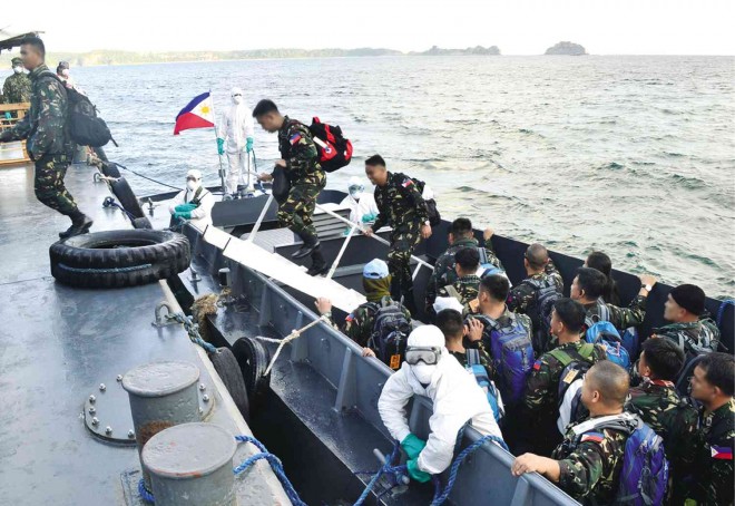 ISLAND QUARANTINE Filipino peacekeepers who returned from Ebola-hit Liberia arrive on Caballo Island, off Cavite province, on Wednesday to be quarantined for 21 days as part of the government protocol to keep the Philippines free of the dreaded disease. One of them with a fever was flown to a government hospital on Friday. PHOTO FROM NAVAL PUBLIC AFFAIRS OFFICE 