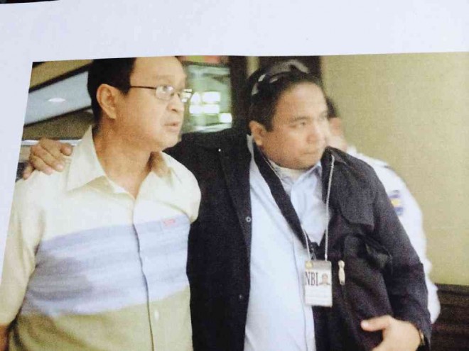 THE ARRESTED Raul Desembrana (left) is brought to the NBI headquarters following the entrapment operation in Quezon City on Friday. 