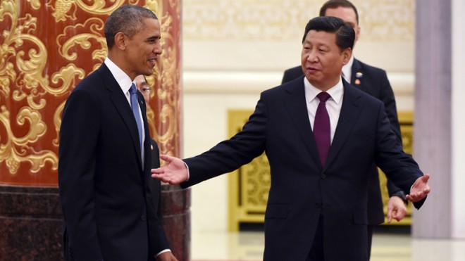 Chinese President Xi Jinping, right, gestures to U.S. President Barack Obama as they arrive at a lunch banquet in the Great Hall of the People in Beijing Wednesday, Nov. 12, 2014. Obama is on a state visit after attending the Asia-Pacific Economic Cooperation summit in Beijing. (AP Photo/Greg Baker, Pool)
