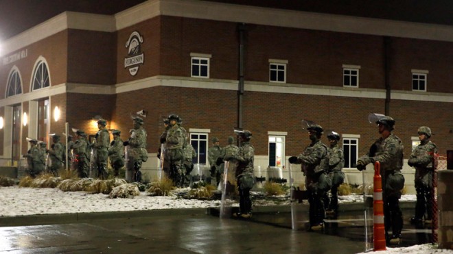 Missouri National Guard stand outside of the Ferguson Police Department Wednesday, Nov. 26, 2014, in Ferguson, Mo. A grand jury's decision not to indict a police officer in the shooting death of an unarmed 18-year-old has stoked passions nationwide, triggering debates over the relations between black communities and law enforcement. (AP Photo/Jeff Roberson)
