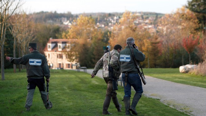 Members of the police animal brigade walk through the streets of Montevrain, east of Paris, Thursday Nov. 13, 2014. French authorities say a young tiger is on the loose near Disneyland Paris, one of Europe's top tourist destinations, and have urged residents in three towns to stay indoors. (AP Photo/Thibault Camus)