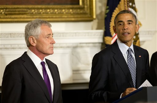 President Barack Obama, standing with Defense Secretary Chuck Hagel, talks about Hagel's resignation during an event in the State Dining Room of the White House in Washington, Monday, Nov. 24, 2014. Hagel is stepping down under pressure from Obama's Cabinet, senior administration officials said Monday, following a tenure in which he has struggled to break through the White House's insular foreign policy team. AP PHOTO/PABLO MARTINEZ MONSIVAIS