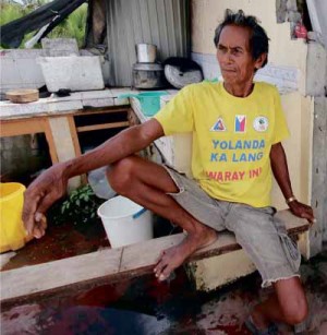 LOOKINGHIS FUTURE IN THE EYE Ireneo Pasacao, 62, lost 31 members of his family a year ago. His T-shirt, however, shows his determination to survive the tragedy and begin anew. DANNY PETILLA/CONTRIBUTOR