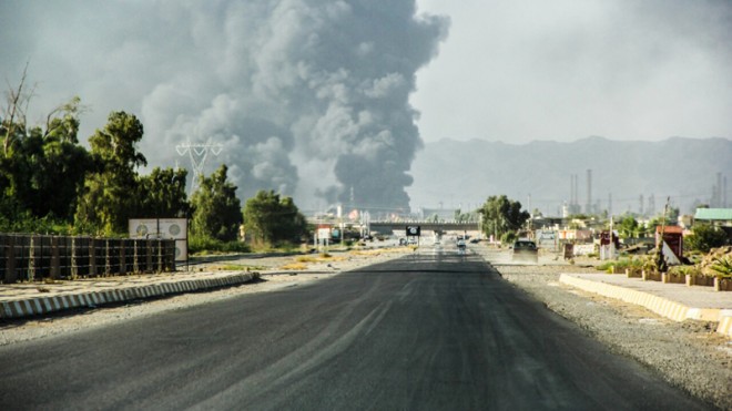 In this Thursday, July 31, 2014 file photo, a column of smoke rises from an oil refinery in Beiji, some 250 kilometers (155 miles) north of Baghdad, Iraq, after an attack by Islamic militants. Iraqi soldiers battling the Islamic State group recaptured the heart of the town of Beiji, home to the country's largest oil refinery, state television and a military official said Tuesday, Nov. 11, 2014. Retaking Beiji, could allow Iraqi forces a base to attack neighboring Tikrit, taken by the extremists after their lightning advance this summer. (AP Photo, File)