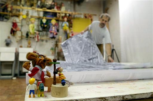 In this photo taken Saturday, Nov. 1, 2014, puppet designer and film maker Miroslav Trejtnar prepares a map for animations of his movie 'What to tell to kids?" in a studio in Prague, Czech Republic. AP