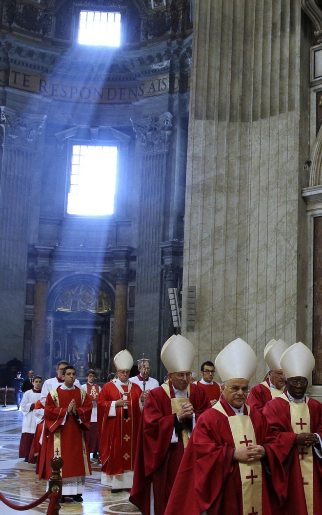 Pope Francis, fifth from left, arrives for a Mass for cardinals and bishops who died in the past year, in St. Peter's Basilica at the Vatican, Monday, Nov. 3, 2014. Each year, a few days after All Soul's Day, a Catholic Church feast commemorating the dead, the pope says a Mass for deceased prelates. (AP Photo/Gregorio Borgia)