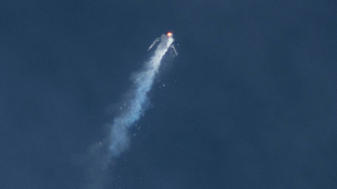 The Virgin Galactic SpaceShipTwo rocket explodes in the air during a test flight on Friday, Oct. 31, 2014. The explosion killed a pilot aboard and seriously injured another while scattering wreckage in Southern California's Mojave Desert, witnesses and officials said. (AP Photo/Kenneth Brown)