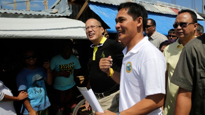 President Aquino listens to the updates on the rehabilitation efforts given by Guiuan Municipal Mayor Christopher Sheen Gonzales at the Guiuan Public Market in Barangay 6, Poblacion, Guiuan, during his visit to Eastern Samar Nov. 7, 2014, the eve of the typhoon Yolanda anniversary. He skipped Tacloban, which suffered the brunt of the super typhoon, due to, what many people suspect, political considerations. Photo by Gil Nartea/ Malacañang Photo bureau