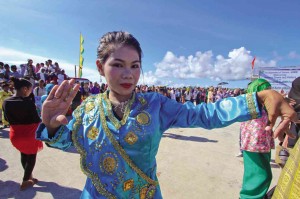 DRESSED in traditional attire, a girl performs a local dance at the port of Simunul town in Tawi-Tawi province to welcome guests at the 25th anniversary celebration of the Autonomous Region in Muslim Mindanao. 