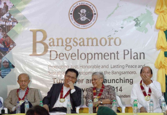 (FROM LEFT) Malaysian facilitator Tengku Dato Abd Ghafar Bin Tenku Mohamed, Moro Islamic Liberation Front (MILF) chair Murad Ebrahim, Presidential Adviser on the Peace Process Teresita Deles and Budget Secretary Butch Abad attend on Nov. 2 the hand-over ceremony of the Bangsamoro Development Plan, the road map to human and sustainable development for people affected by decades of conflicts in Mindanao, at Darapanan, the main camp of the MILF in Sultan Kudarat, Maguindanao province. JEOFFREY MAITEM/INQUIRER MINDANAO